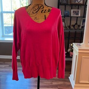 Hot pink sweater vneck with side slits at bottom